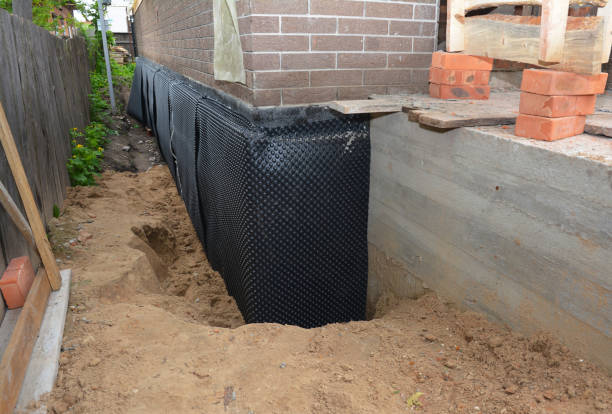 SJ Waterproofing Pros technician performing targeted Basement Waterproofing assessment in Douglass, KS